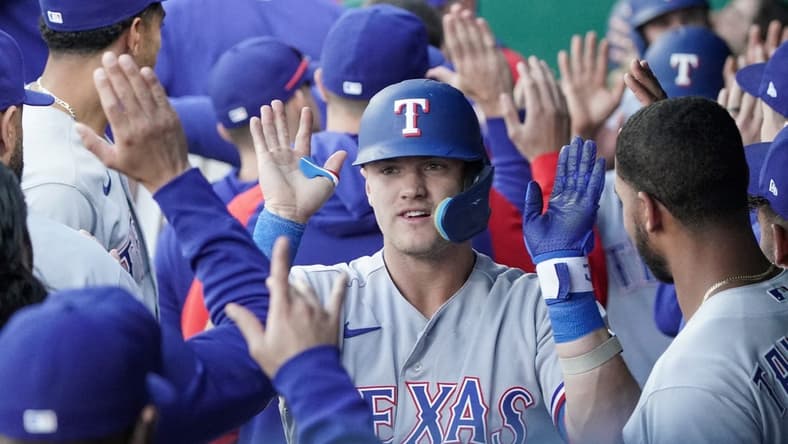 Apr 17, 2023; Kansas City, Missouri, USA; Texas Rangers third baseman Josh Jung (6) is congratulated in the dugout after hitting a three run home run against the Kansas City Royals in the first inning at Kauffman Stadium. Mandatory Credit: Denny Medley-USA TODAY Sports
