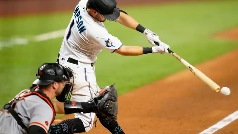 Apr 17, 2023; Miami, Florida, USA; Miami Marlins shortstop Garrett Hampson (1) hits a single against the San Francisco Giants during the sixth inning at loanDepot Park. Mandatory Credit: Rich Storry-USA TODAY Sports