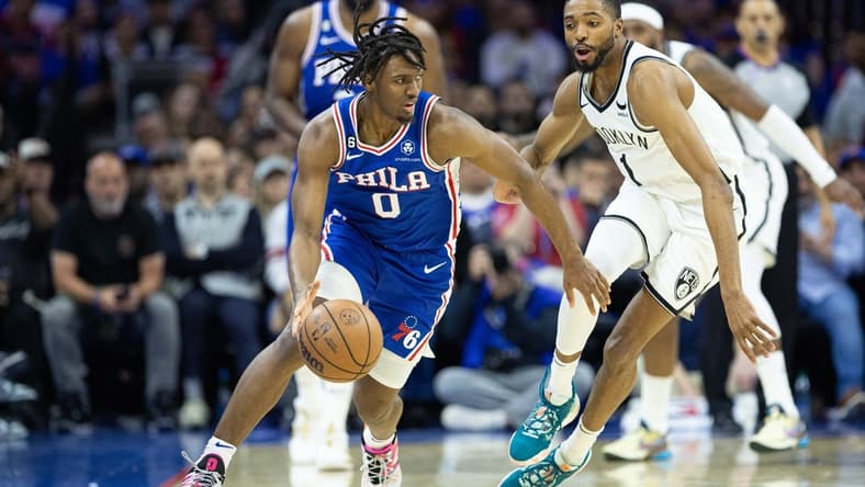 Apr 17, 2023; Philadelphia, Pennsylvania, USA; Philadelphia 76ers guard Tyrese Maxey (0) dribbles the ball  in front of Brooklyn Nets forward Mikal Bridges (1) during the second quarter in game two of the 2023 NBA playoffs at Wells Fargo Center. Mandatory Credit: Bill Streicher-USA TODAY Sports