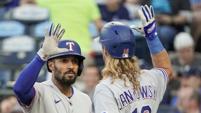 Apr 17, 2023; Kansas City, Missouri, USA; Texas Rangers second baseman Marcus Semien (2) celebrates with right fielder Travis Jankowski (16) after hitting a solo home run against the Kansas City Royals in the third inning at Kauffman Stadium. Mandatory Credit: Denny Medley-USA TODAY Sports