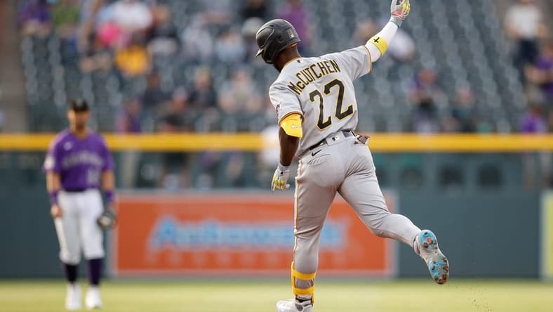 Apr 17, 2023; Denver, Colorado, USA; Pittsburgh Pirates designated hitter Andrew McCutchen (22) raises his hand as he rounds the bases on a solo home run in the first inning against the Colorado Rockies at Coors Field. Mandatory Credit: Isaiah J. Downing-USA TODAY Sports