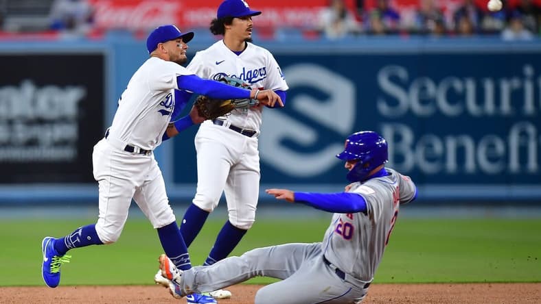 Apr 17, 2023; Los Angeles, California, USA; New York Mets first baseman Pete Alonso (20) is out at second as Los Angeles Dodgers shortstop Miguel Rojas (11) throws to first during the second inning at Dodger Stadium. Mandatory Credit: Gary A. Vasquez-USA TODAY Sports