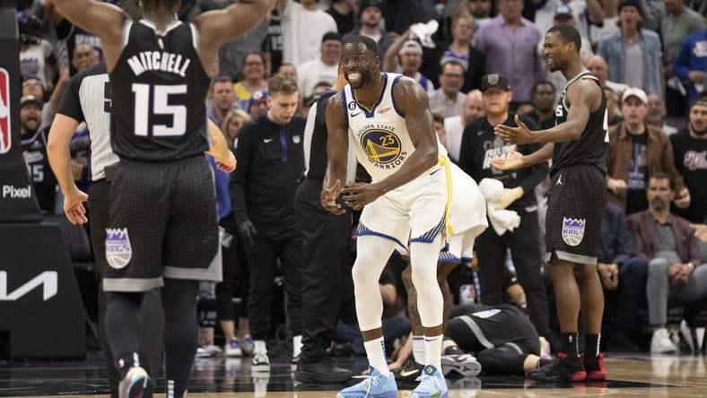 April 17, 2023; Sacramento, California, USA; Golden State Warriors forward Draymond Green (23) reacts towards the referee after a play with Sacramento Kings forward Domantas Sabonis (10) laying on the court during the fourth quarter in game two of the first round of the 2023 NBA playoffs at Golden 1 Center. Mandatory Credit: Kyle Terada-USA TODAY Sports