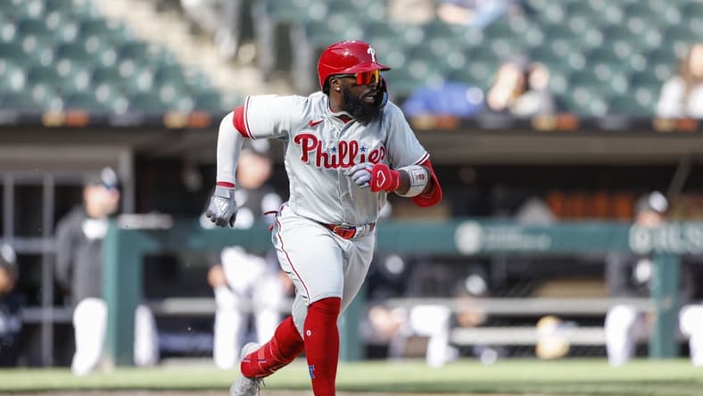 Apr 18, 2023; Chicago, Illinois, USA; Philadelphia Phillies second baseman Josh Harrison (2) runs to first base after hitting a two-run single against the Chicago White Sox during the third inning of game one of the doubleheader at Guaranteed Rate Field. Mandatory Credit: Kamil Krzaczynski-USA TODAY Sports