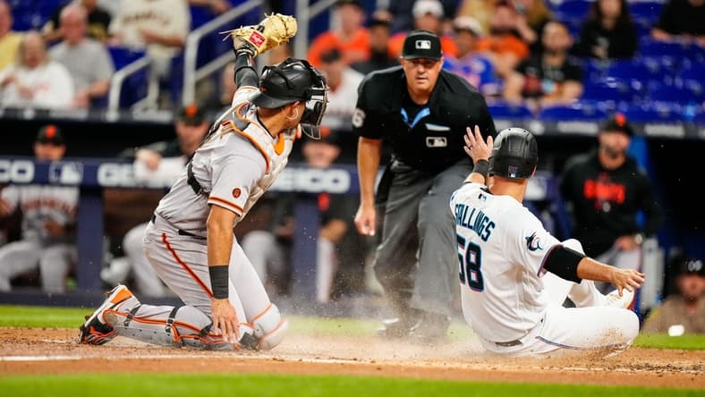 Apr 18, 2023; Miami, Florida, USA; San Francisco Giants catcher Blake Sabol (2) attempts to tag Miami Marlins catcher Jacob Stallings (58) as he slides into home base during the third inning at loanDepot Park. Mandatory Credit: Rich Storry-USA TODAY Sports