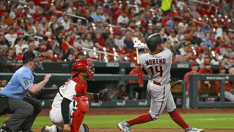 Apr 18, 2023; St. Louis, Missouri, USA;  Arizona Diamondbacks catcher Gabriel Moreno (14) hits a three run home run against the St. Louis Cardinals during the fourth inning at Busch Stadium. Mandatory Credit: Jeff Curry-USA TODAY Sports