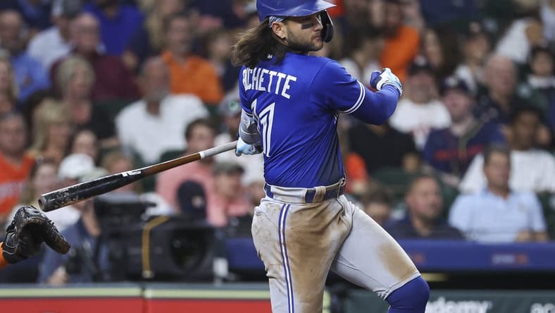 Apr 18, 2023; Houston, Texas, USA; Toronto Blue Jays shortstop Bo Bichette (11) hits an RBI single during the fifth inning against the Houston Astros at Minute Maid Park. Mandatory Credit: Troy Taormina-USA TODAY Sports