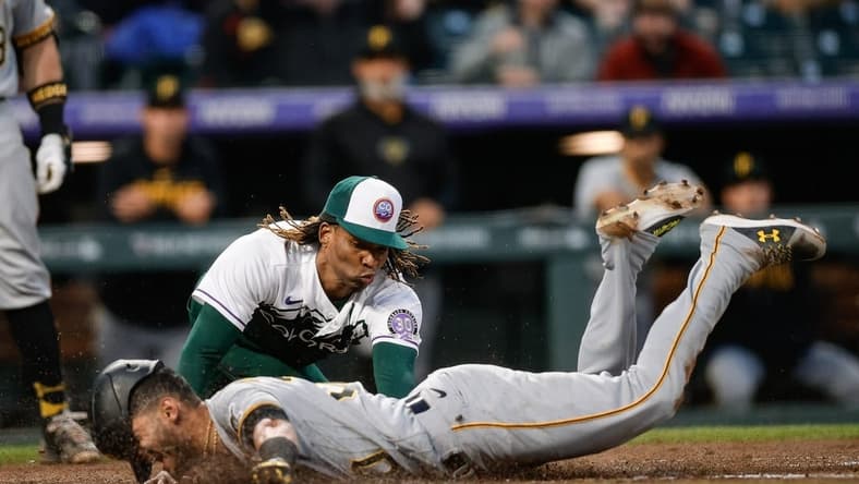 Apr 18, 2023; Denver, Colorado, USA; Pittsburgh Pirates second baseman Tucupita Marcano (30) safely slides into home as Colorado Rockies starting pitcher Jose Urena (51) attempts to apply the tag after throwing a wild pitch in the fourth inning at Coors Field. Mandatory Credit: Isaiah J. Downing-USA TODAY Sports