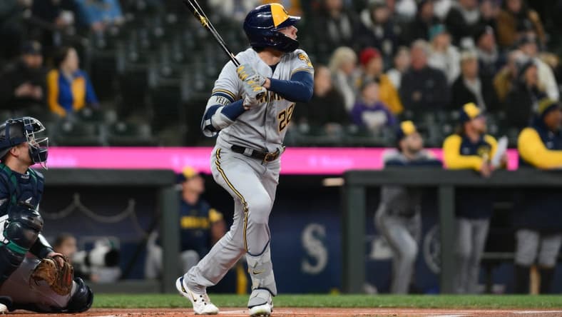 Apr 18, 2023; Seattle, Washington, USA; Milwaukee Brewers left fielder Christian Yelich (22) hits a home run against the Seattle Mariners during the first inning at T-Mobile Park. Mandatory Credit: Steven Bisig-USA TODAY Sports