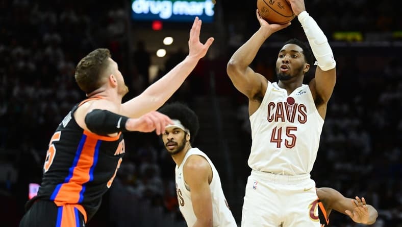 Apr 18, 2023; Cleveland, Ohio, USA; Cleveland Cavaliers guard Donovan Mitchell (45) shoots over the defense of New York Knicks center Isaiah Hartenstein (55) during the second half of game two of the 2023 NBA playoffs at Rocket Mortgage FieldHouse. Mandatory Credit: Ken Blaze-USA TODAY Sports