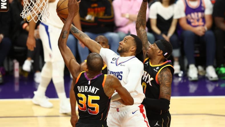 Apr 18, 2023; Phoenix, Arizona, USA; Los Angeles Clippers guard Norman Powell (center) drives to the basket against Phoenix Suns forward Kevin Durant (35) and Torrey Craig in the second half during game two of the 2023 NBA playoffs at Footprint Center. Mandatory Credit: Mark J. Rebilas-USA TODAY Sports