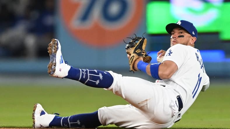 Apr 18, 2023; Los Angeles, California, USA; Los Angeles Dodgers shortstop Miguel Rojas (11) tries to make a play but can   t get New York Mets shortstop Francisco Lindor (12) out at first in the fourth inning at Dodger Stadium. Mandatory Credit: Jayne Kamin-Oncea-USA TODAY Sports
