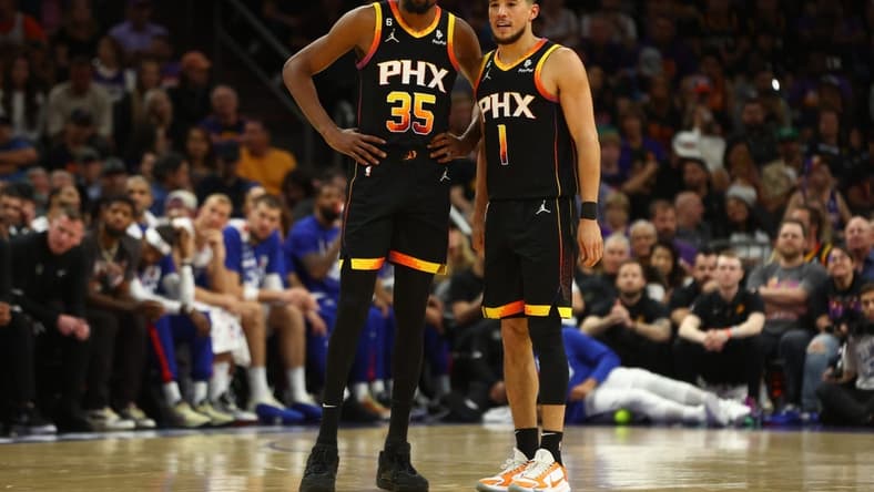 Apr 18, 2023; Phoenix, Arizona, USA; Phoenix Suns guard Devin Booker (1) with forward Kevin Durant (35) against the Los Angeles Clippers in the second half during game two of the 2023 NBA playoffs at Footprint Center. Mandatory Credit: Mark J. Rebilas-USA TODAY Sports