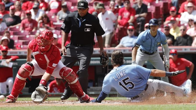 Apr 19, 2023; Cincinnati, Ohio, USA; Tampa Bay Rays right fielder Josh Lowe (15) scores a run past Cincinnati Reds catcher Luke Maile (22) during the first inning at Great American Ball Park. Mandatory Credit: David Kohl-USA TODAY Sports