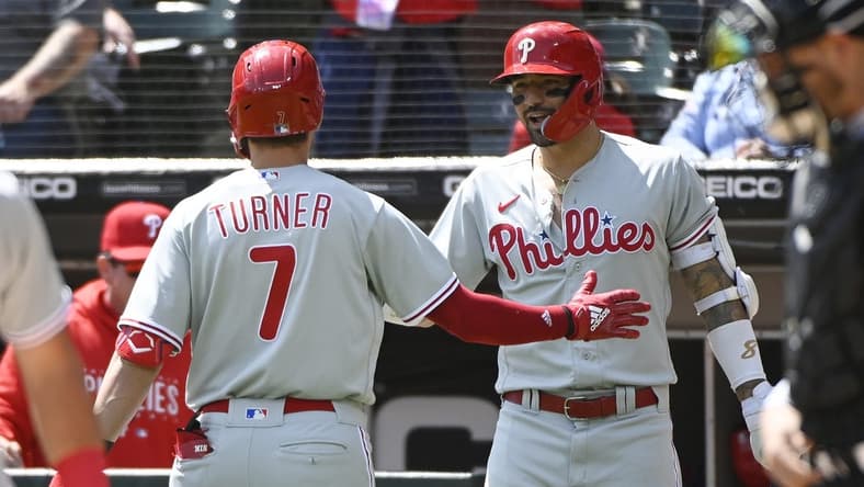 Apr 19, 2023; Chicago, Illinois, USA;  Philadelphia Phillies shortstop Trea Turner (7)  high fives Philadelphia Phillies right fielder Nick Castellanos (8), right, after he hits a home run against the Chicago White Sox during the first inning at Guaranteed Rate Field. Mandatory Credit: Matt Marton-USA TODAY Sports