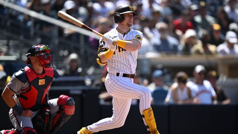 Apr 19, 2023; San Diego, California, USA; San Diego Padres first baseman Jake Cronenworth (9) hits a double against the Atlanta Braves during the fourth inning at Petco Park. Mandatory Credit: Orlando Ramirez-USA TODAY Sports