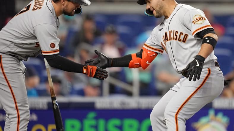 Apr 19, 2023; Miami, Florida, USA;  San Francisco Giants right fielder Michael Conforto (right) celebrates a two-run home run with first baseman J.D. Davis (7) in the se inning against the Miami Marlins at loanDepot Park. Mandatory Credit: Jim Rassol-USA TODAY Sports