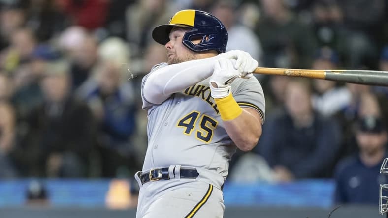 Apr 19, 2023; Seattle, Washington, USA; Milwaukee Brewers first baseman Luke Voit (45) hits an RBI-single during the seventh inning against the Seattle Mariners at T-Mobile Park. Mandatory Credit: Stephen Brashear-USA TODAY Sports