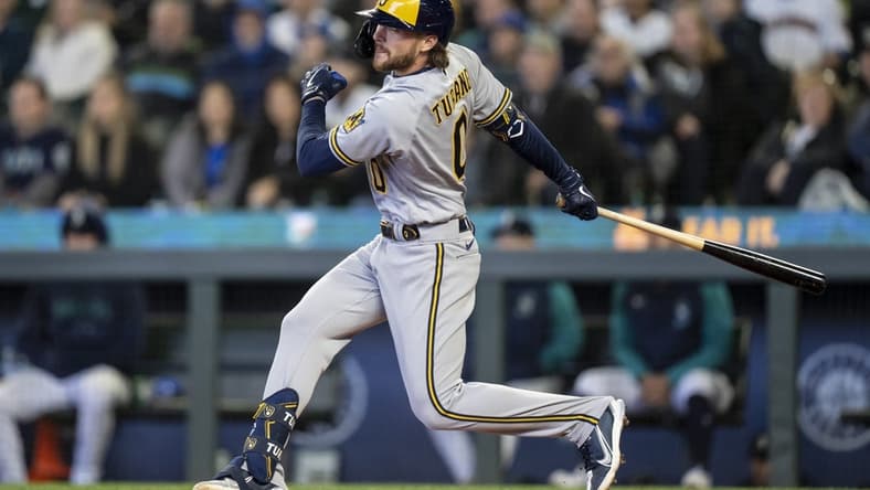 Apr 19, 2023; Seattle, Washington, USA; Milwaukee Brewers second baseman Brice Turang (0) hits a two-run double during the seventh inning against the Seattle Mariners at T-Mobile Park. Mandatory Credit: Stephen Brashear-USA TODAY Sports