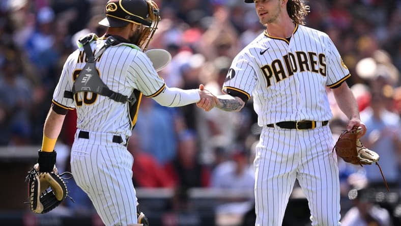 Apr 19, 2023; San Diego, California, USA; San Diego Padres catcher Austin Nola (26) and relief pitcher Josh Hader (71) shake hands after defeating the Atlanta Braves at Petco Park. Mandatory Credit: Orlando Ramirez-USA TODAY Sports
