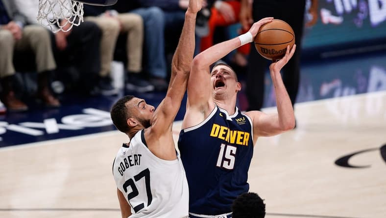 Apr 19, 2023; Denver, Colorado, USA; Denver Nuggets center Nikola Jokic (15) drives to the net against Minnesota Timberwolves center Rudy Gobert (27) in the second quarter during game two of the 2023 NBA Playoffs at Ball Arena. Mandatory Credit: Isaiah J. Downing-USA TODAY Sports