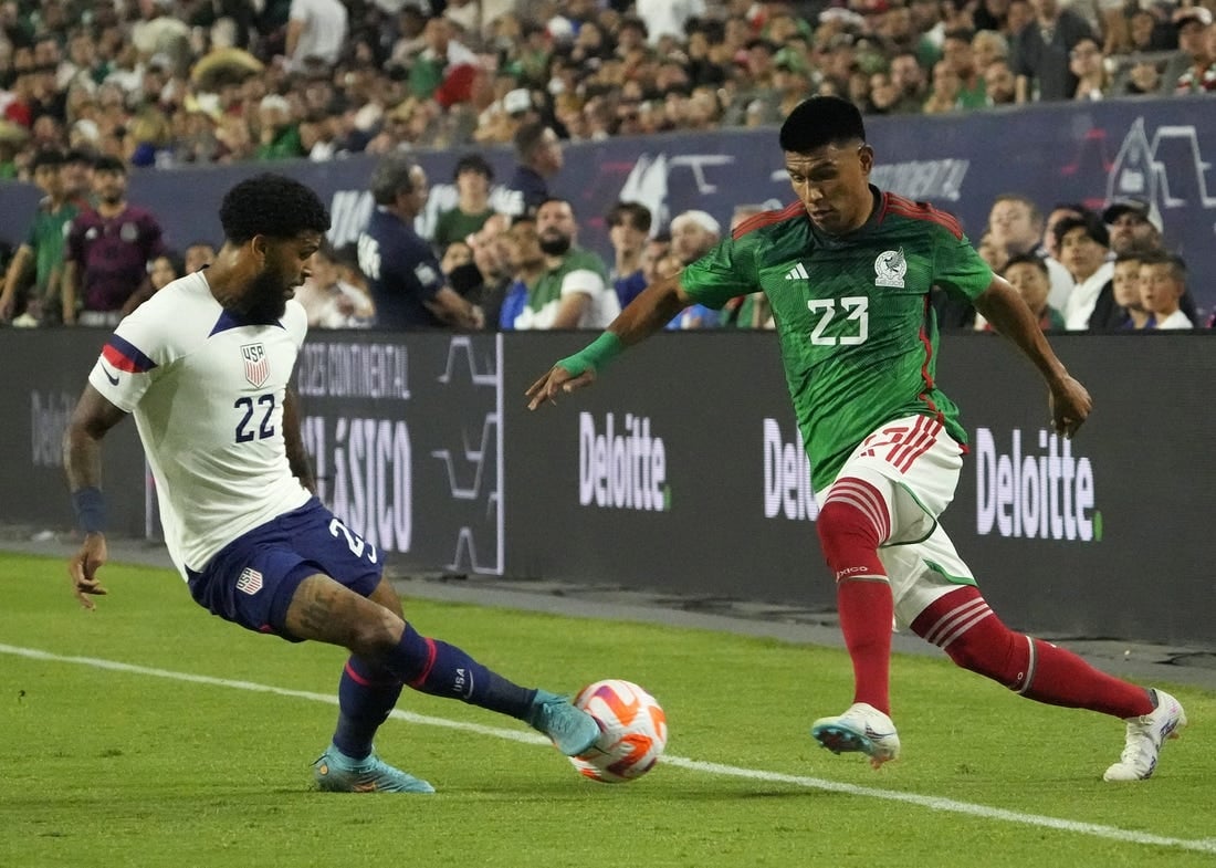 Apr 19, 2023; Glendale, Ariz., U.S.;  United States defender DeAndre Yedlin (22) kicks the ball away from Mexico defender Jesus Gallardo (23) during the Allstate Continental Classico at State Farm Stadium. Mandatory Credit: Michael Chow-Arizona Republic

Soccer U S Mexico Men S Soccer