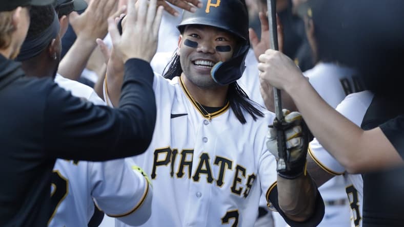 Apr 20, 2023; Pittsburgh, Pennsylvania, USA;  Pittsburgh Pirates right fielder Connor Joe (2) celebrates in the dugout after hitting a three run home run against the Cincinnati Reds during the first inning at PNC Park. Mandatory Credit: Charles LeClaire-USA TODAY Sports