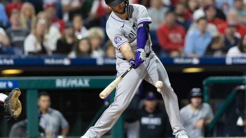 Apr 20, 2023; Philadelphia, Pennsylvania, USA; Colorado Rockies first baseman C.J. Cron (25) hits a single during the sixth inning against the Philadelphia Phillies at Citizens Bank Park. Mandatory Credit: Bill Streicher-USA TODAY Sports