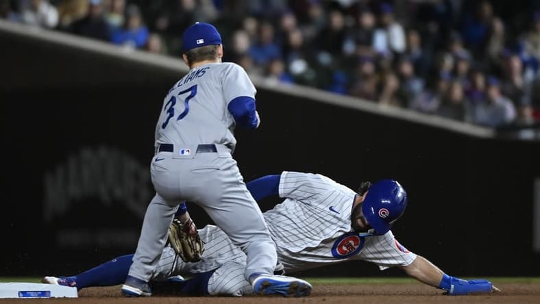 Apr 20, 2023; Chicago, Illinois, USA;  Chicago Cubs shortstop Dansby Swanson (7) slides safely into second base under Los Angeles Dodgers right fielder Luke Williams (37) during the first inning at Wrigley Field. Mandatory Credit: Matt Marton-USA TODAY Sports