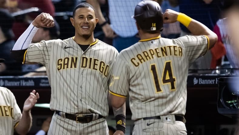 Apr 20, 2023; Phoenix, Arizona, USA; San Diego Padres first baseman Matt Carpenter (14) celebrates with teammate Manny Machado after hitting a solo home run in the fourth inning against the Arizona Diamondbacks at Chase Field. Mandatory Credit: Mark J. Rebilas-USA TODAY Sports