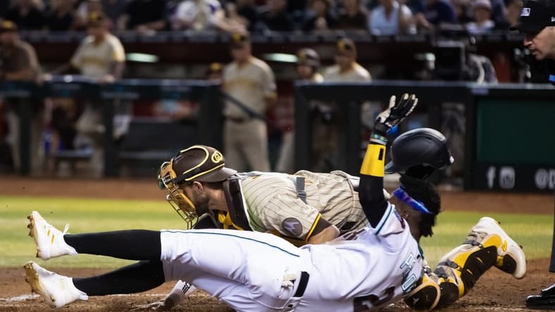 Apr 20, 2023; Phoenix, Arizona, USA; Arizona Diamondbacks base runner Geraldo Perdomo (2) scores ahead of the tag by San Diego Padres catcher Austin Nola in the fourth inning at Chase Field. Mandatory Credit: Mark J. Rebilas-USA TODAY Sports