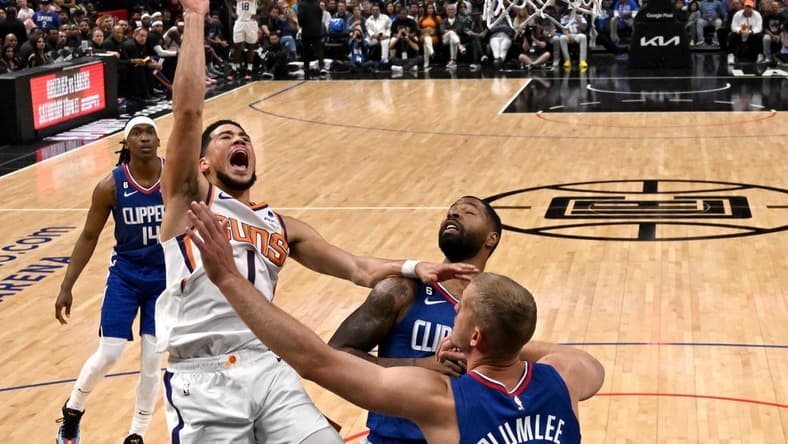Apr 20, 2023; Los Angeles, California, USA; Phoenix Suns guard Devin Booker (1) drives past Los Angeles Clippers forward Marcus Morris Sr. (8) and center Mason Plumlee (44) for a basket in the first half at Crypto.com Arena. Mandatory Credit: Jayne Kamin-Oncea-USA TODAY Sports