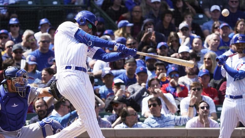 Apr 21, 2023; Chicago, Illinois, USA; Chicago Cubs center fielder Cody Bellinger (24) hits a home run against the Los Angeles Dodgers during the third inning at Wrigley Field. Mandatory Credit: David Banks-USA TODAY Sports
