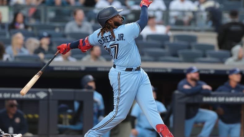 Apr 21, 2023; Bronx, New York, USA; Toronto Blue Jays first baseman Vladimir Guerrero Jr. (27) hits a two run home run during the first inning against the New York Yankees at Yankee Stadium. Mandatory Credit: Vincent Carchietta-USA TODAY Sports