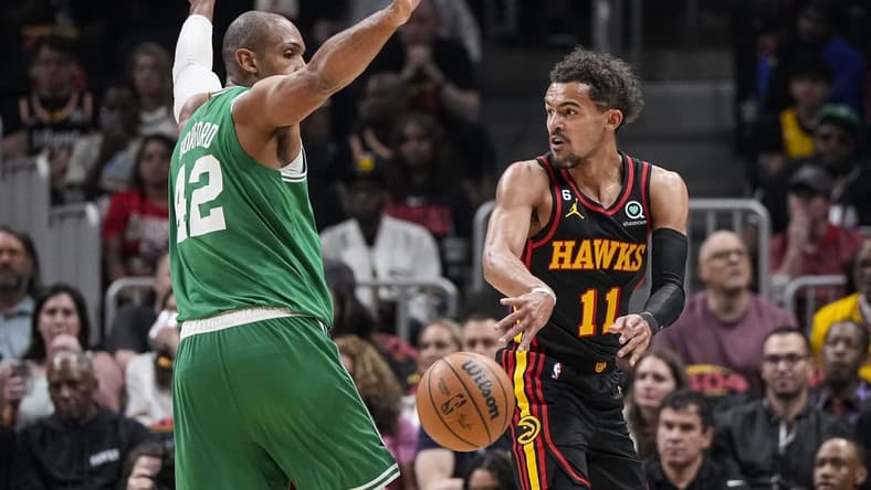 Apr 21, 2023; Atlanta, Georgia, USA; Atlanta Hawks guard Trae Young (11) passes behind Boston Celtics center Al Horford (42) during the first half during game three of the 2023 NBA playoffs at State Farm Arena. Mandatory Credit: Dale Zanine-USA TODAY Sports