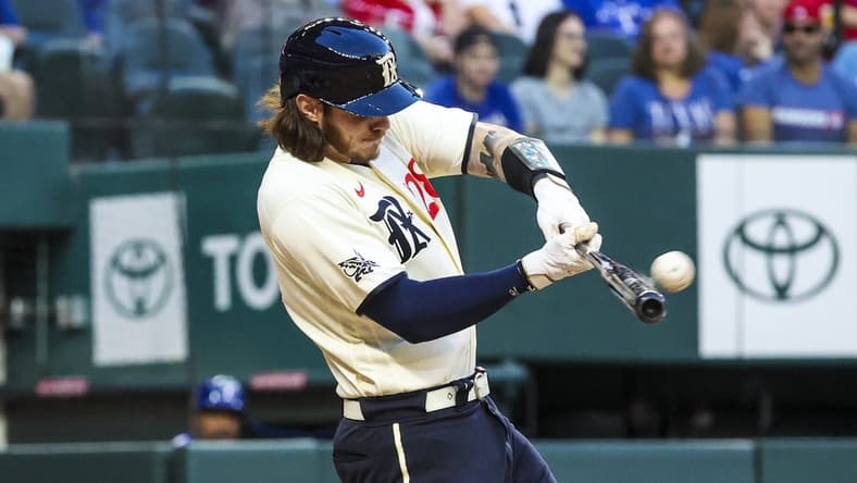 Apr 21, 2023; Arlington, Texas, USA;  Texas Rangers catcher Jonah Heim (28) hits a three-run home run during the first inning against the Oakland Athletics  at Globe Life Field. Mandatory Credit: Kevin Jairaj-USA TODAY Sports