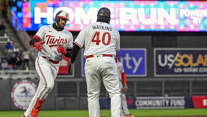 Apr 21, 2023; Minneapolis, Minnesota, USA; Minnesota Twins infielder Joey Gallo (left) celebrates his solo home run against the Washington National with third base coach Tommy Watkins (40) during the third inning at Target Field. Mandatory Credit: Nick Wosika-USA TODAY Sports