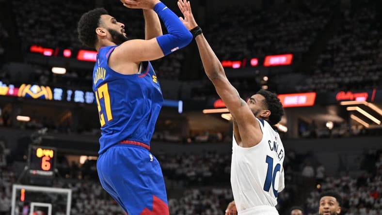 Apr 21, 2023; Minneapolis, Minnesota, USA; Denver Nuggets guard Jamal Murray (27) is defended by Minnesota Timberwolves guard Mike Conley (10) during the second quarter of game three of the 2023 NBA Playoffs at Target Center. Mandatory Credit: Jeffrey Becker-USA TODAY Sports