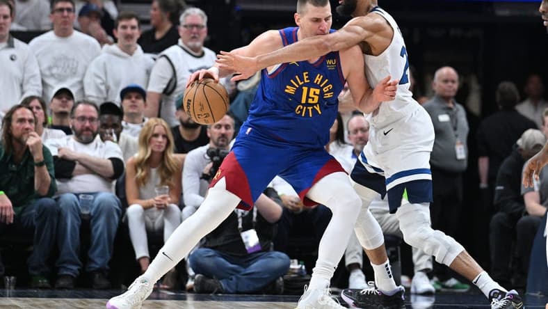 Apr 21, 2023; Minneapolis, Minnesota, USA; Denver Nuggets center Nikola Jokic (15) is defended by Minnesota Timberwolves center Rudy Gobert (27) during the fourth quarter of game three of the 2023 NBA Playoffs at Target Center. Mandatory Credit: Jeffrey Becker-USA TODAY Sports