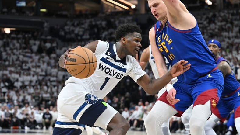 Apr 21, 2023; Minneapolis, Minnesota, USA; Minnesota Timberwolves guard Anthony Edwards (1) goes to the basket as Denver Nuggets center Nikola Jokic (15) defends during the fourth quarter of game three of the 2023 NBA Playoffs at Target Center. Mandatory Credit: Jeffrey Becker-USA TODAY Sports