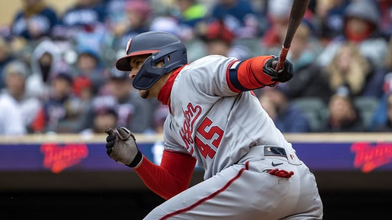 Apr 22, 2023; Minneapolis, Minnesota, USA; Washington Nationals first baseman Joey Meneses (45) hits a RBI ground ball in the first inning against the Minnesota Twins at Target Field. Mandatory Credit: Jesse Johnson-USA TODAY Sports