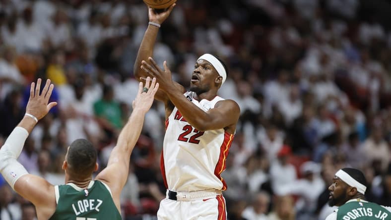 Apr 22, 2023; Miami, Florida, USA; Miami Heat forward Jimmy Butler (22) shoots the basketball over Milwaukee Bucks center Brook Lopez (11) in the first quarter during game three of the 2023 NBA Playoffs at Kaseya Center. Mandatory Credit: Sam Navarro-USA TODAY Sports