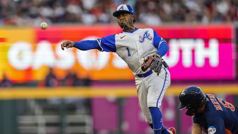 Apr 22, 2023; Cumberland, Georgia, USA; Atlanta Braves second baseman Ozzie Albies (1) throws to first base for a double play next to Houston Astros center fielder Jake Meyers (6) during the second inning at Truist Park. Mandatory Credit: Dale Zanine-USA TODAY Sports