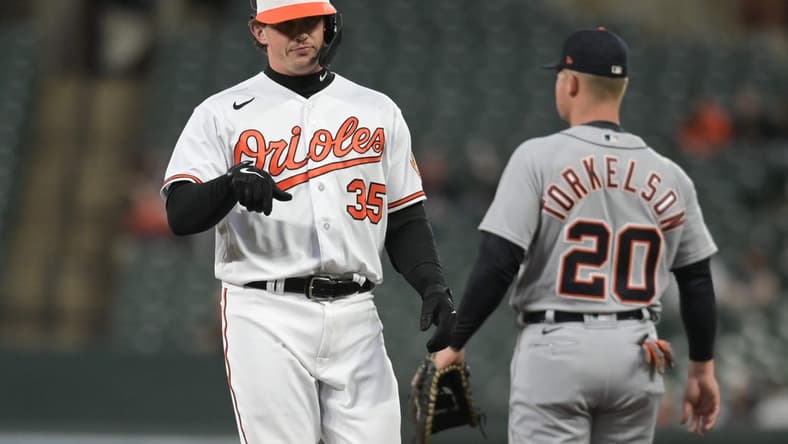 Apr 22, 2023; Baltimore, Maryland, USA; Baltimore Orioles designated hitter  Adley Rutschman (35) reacts after hitting a rbi single in the third inning against the Detroit Tigers at Oriole Park at Camden Yards. Mandatory Credit: Tommy Gilligan-USA TODAY Sports