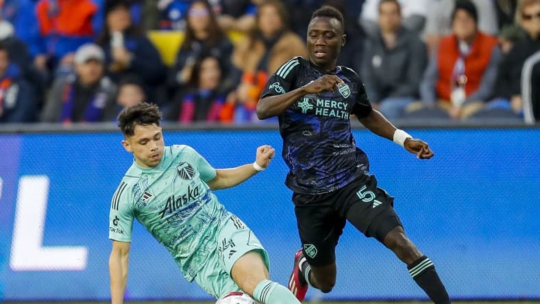 Apr 22, 2023; Cincinnati, Ohio, USA; Portland Timbers midfielder David Ayala (24) dribbles against FC Cincinnati midfielder Obinna Nwobodo (5) in the first half at TQL Stadium. Mandatory Credit: Katie Stratman-USA TODAY Sports