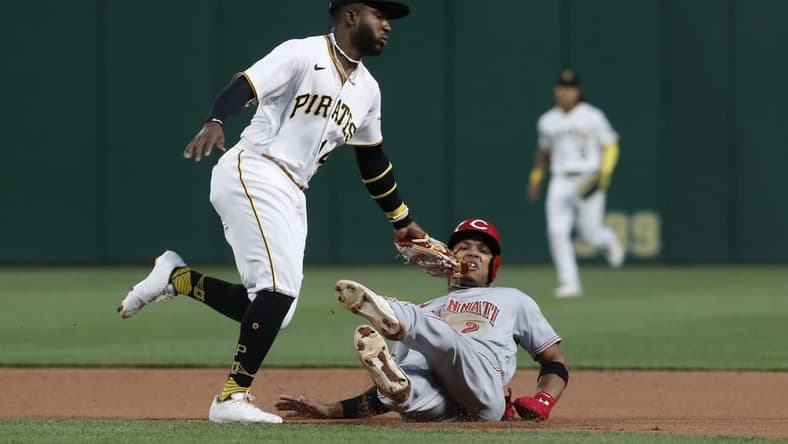 Apr 22, 2023; Pittsburgh, Pennsylvania, USA;  Cincinnati Reds  center fielder Jose Barrero (2) is tagged out between first and second base by Pittsburgh Pirates second baseman Rodolfo Castro (14) as Barrero attempts to steal second base during the fourth inning at PNC Park. Mandatory Credit: Charles LeClaire-USA TODAY Sports