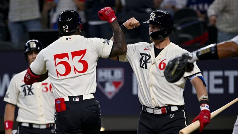Apr 22, 2023; Arlington, Texas, USA; Texas Rangers right fielder Adolis Garcia (53) and third baseman Josh Jung (6) celebrates after Garcia hits a two run home run against the Oakland Athletics during the third inning at Globe Life Field. Mandatory Credit: Jerome Miron-USA TODAY Sports