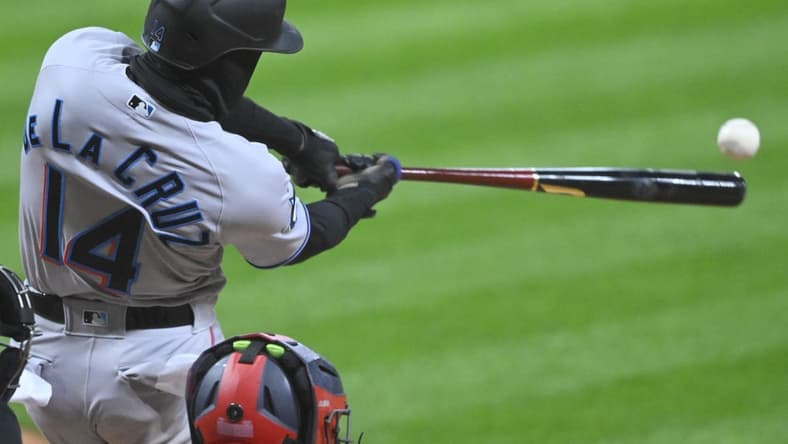 Apr 22, 2023; Cleveland, Ohio, USA; Miami Marlins left fielder Bryan De La Cruz (14) doubles against the Cleveland Guardians in the second inning at Progressive Field. Mandatory Credit: David Richard-USA TODAY Sports