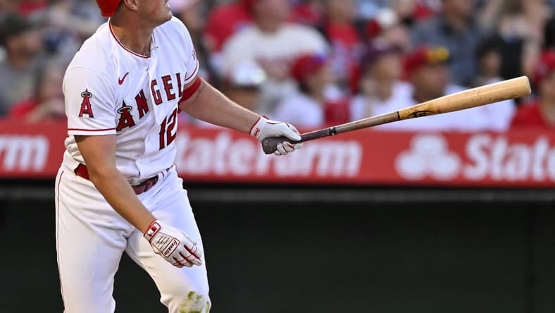 Apr 22, 2023; Anaheim, California, USA;  Los Angeles Angels right fielder Hunter Renfroe (12) hits a solo home run in the fourth inning against the Kansas City Royals at Angel Stadium. Mandatory Credit: Jayne Kamin-Oncea-USA TODAY Sports