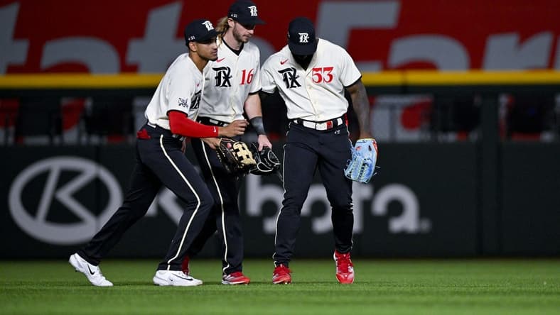 Apr 22, 2023; Arlington, Texas, USA; Texas Rangers left fielder Bubba Thompson (8) and left fielder Travis Jankowski (16) and right fielder Adolis Garcia (53) celebrate the Rangers victory over the Oakland Athletics at Globe Life Field. Mandatory Credit: Jerome Miron-USA TODAY Sports
